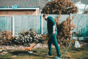 Husband vacuuming backyard